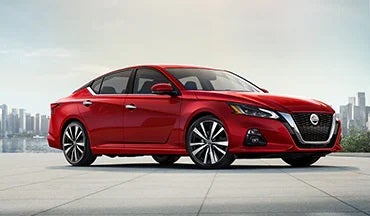 2023 Nissan Altima in red with city in background illustrating last year's 2022 model in Ed Martin Nissan of Fishers in Fishers IN