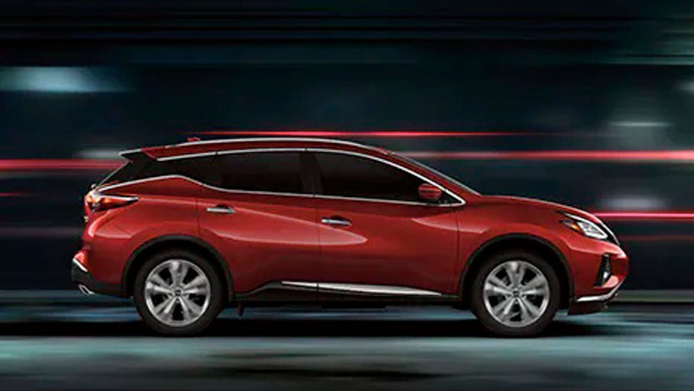 2023 Nissan Murano shown in profile driving down a street at night illustrating performance. | Ed Martin Nissan of Fishers in Fishers IN
