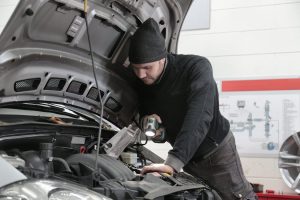 Mechanic working on a car near Fishers, IN 