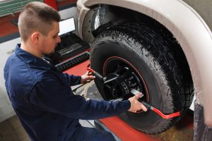 A person performing a tire replacement at a service center near Fishers, Indianapolis.