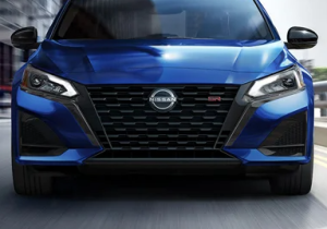 A close up of the headlights on a 2023 Nissan Altima, driving near Fishers, Indiana