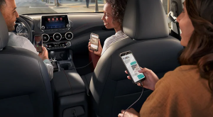 Three people sitting inside a 2024 Nissan Sentra, driving near Fishers, Indiana