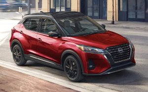 A red 2024 Nissan Kicks parked on a city street near Fishers, Indiana
