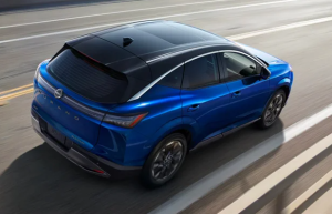 A new blue 2025 Nissan Murano driving down a street near Fishers, Indiana
