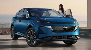 Blue 2026 Nissan Murano with a driver stepping out by the beach