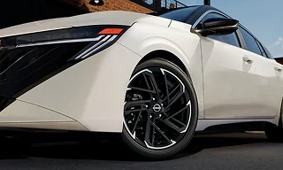 Front wheel and headlight of a white 2026 Nissan Sentra