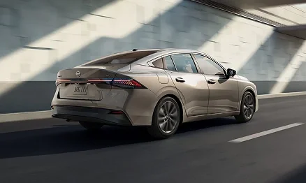 Silver 2026 Nissan Sentra driving through a parking structure