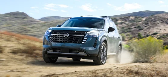 Nissan Pathfinder driving on a dirt trail