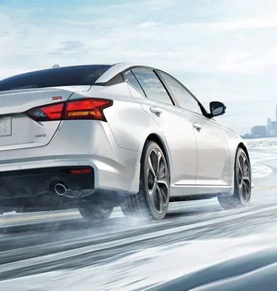 Nissan Altima driving on a snowy road