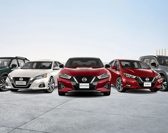 Nissan sedans parked side by side on a lot